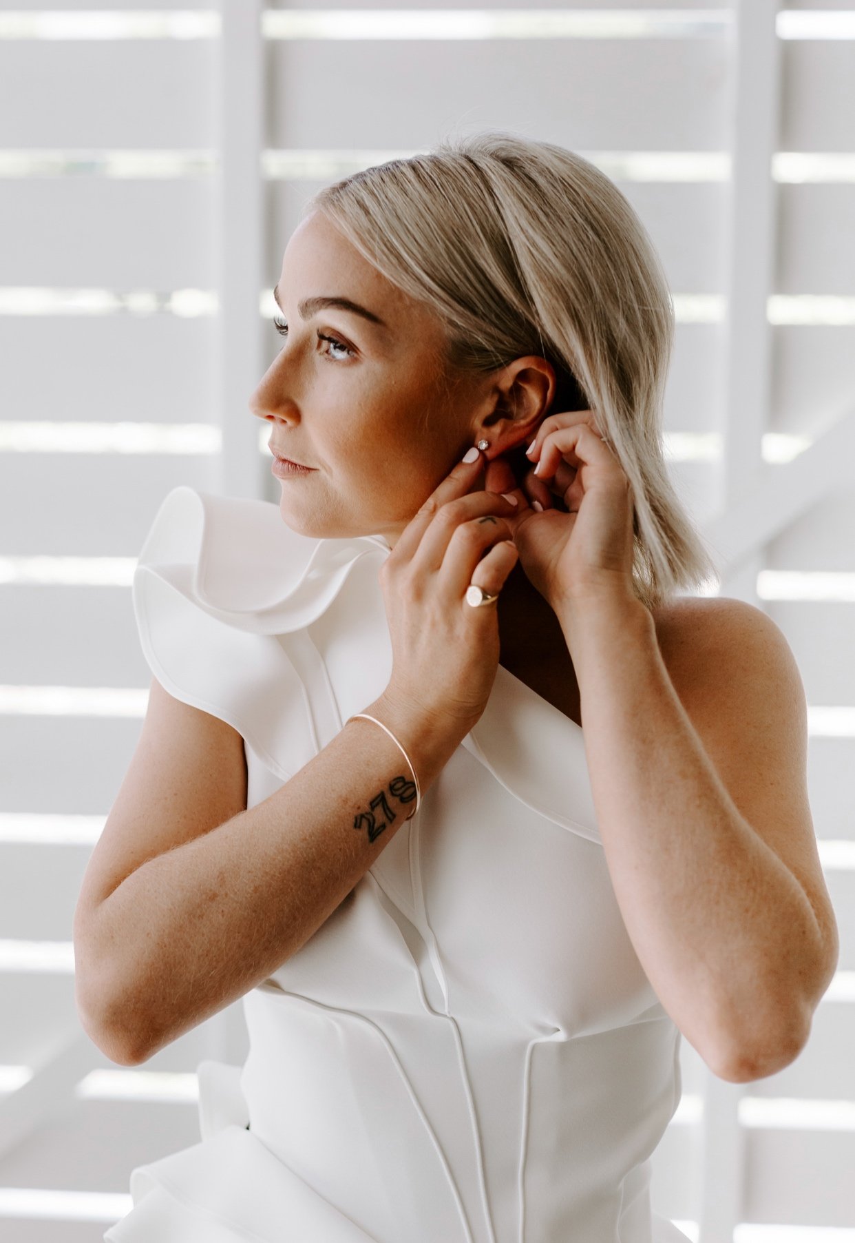 Modern bride in wedding dress with hair and makeup final details