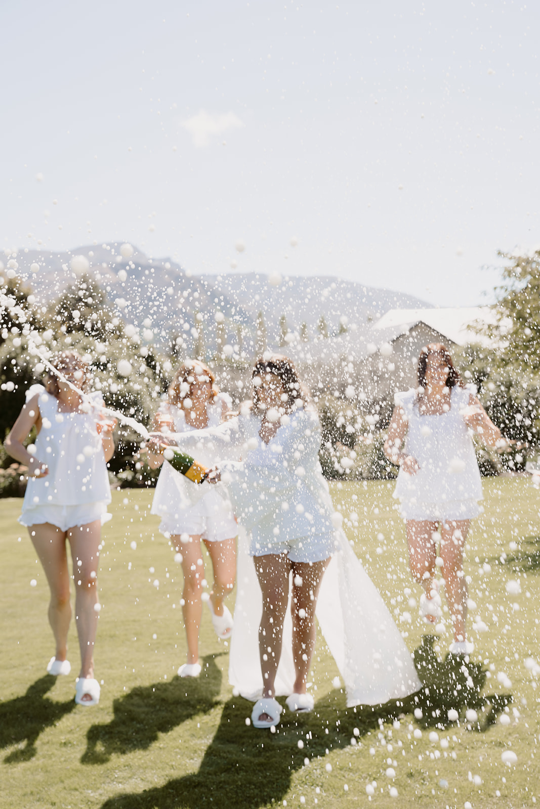Bridal party popping champagne on wedding morning in Queenstown
